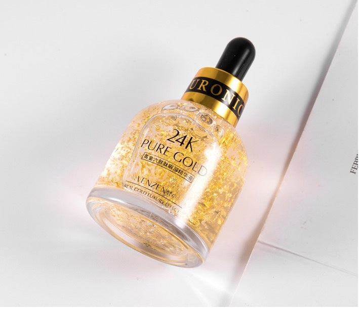 Elegant 24K pure gold eye serum from 6ixDrips skincare brand, with luxurious golden flakes suspended in the formula.