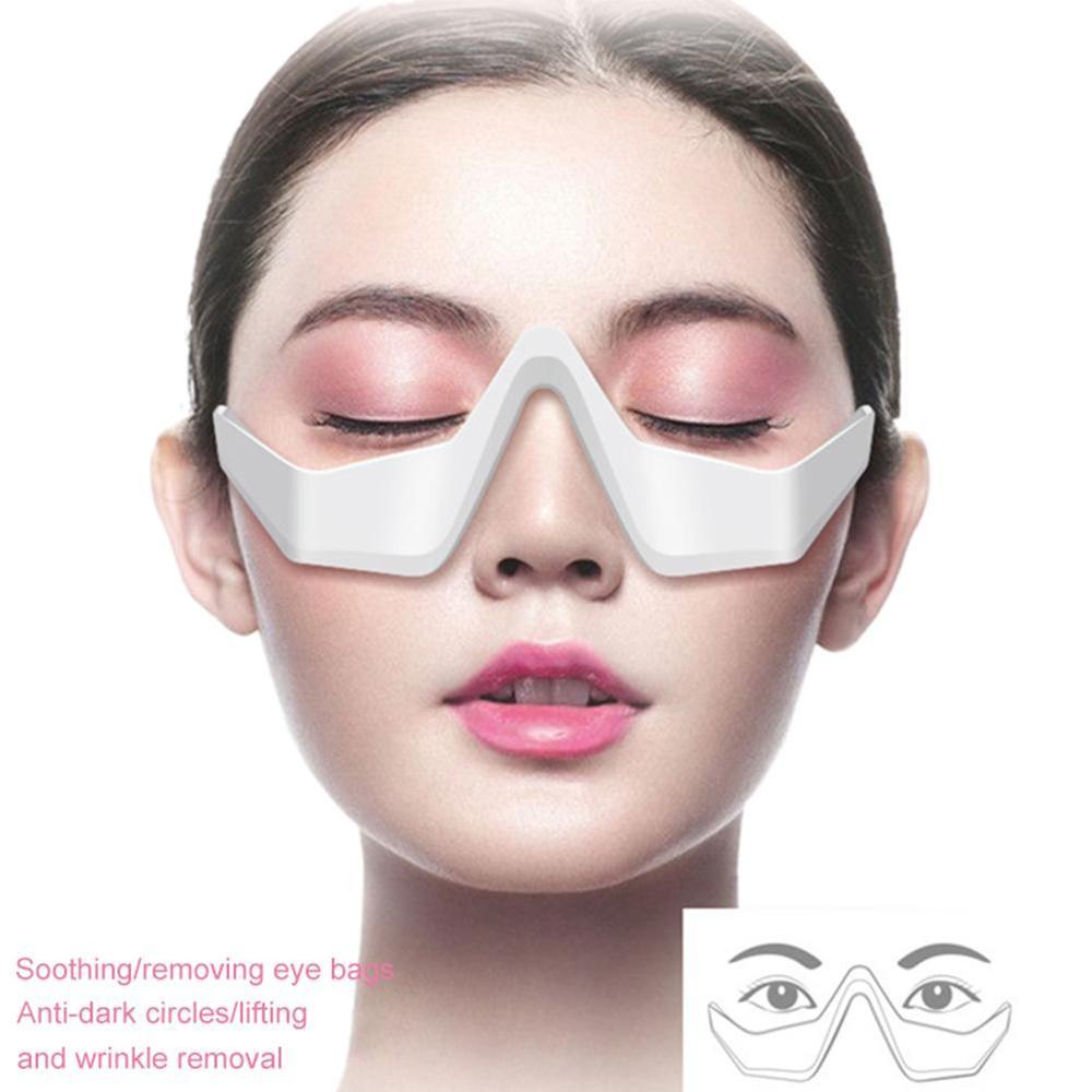 Close-up image of a woman's face wearing a 3D eye beauty instrument, a micro-current pulse eye relax and reduce tool from the 6ixDrips beauty brand. The device features a sleek white design and is positioned over the woman's eyes to provide soothing, anti-aging benefits such as reducing dark circles, lifting and wrinkle removal.