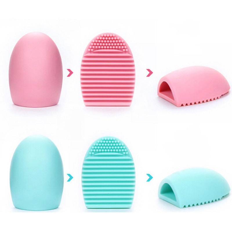 Silicone makeup brush cleansing tool in pink and mint green colors shown in the image for easy makeup brush cleaning and maintenance.