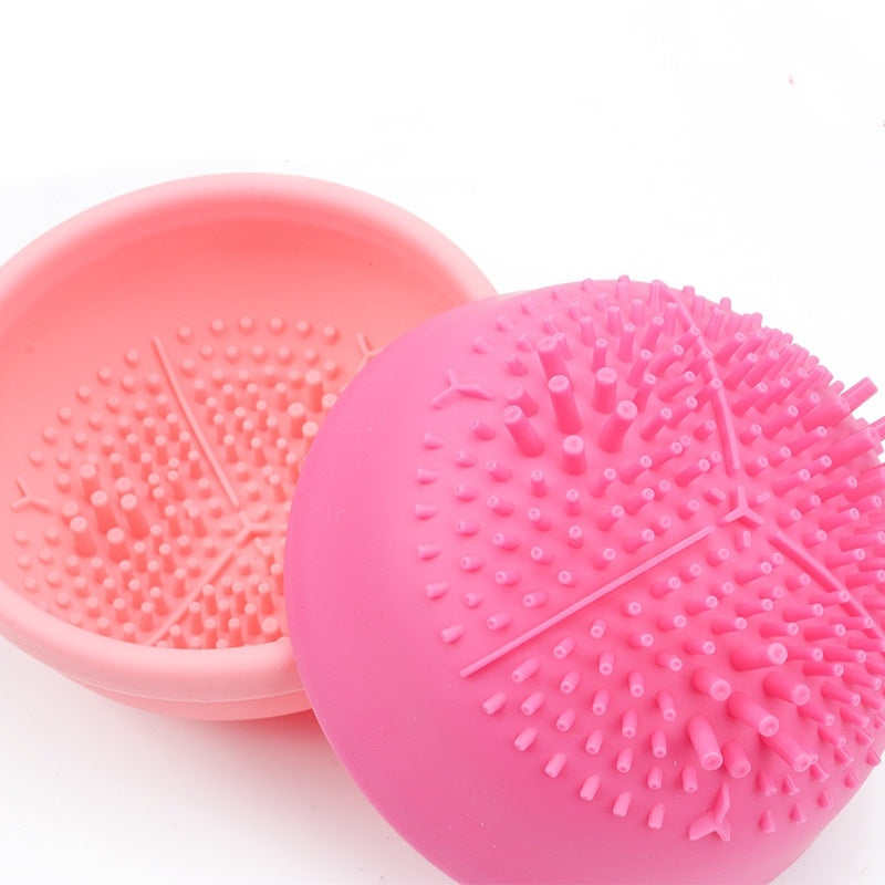 Electric makeup brush cleaning machine, pink and coral spherical cleansing devices with textured bristles for effective makeup tool cleaning.