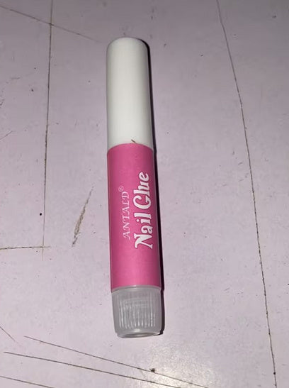 Nail glue in pink and white container from 6ixDrips beauty store