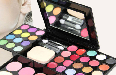 Vibrant makeup palette with assorted eyeshadows, blushes, and brushes for versatile beauty looks.