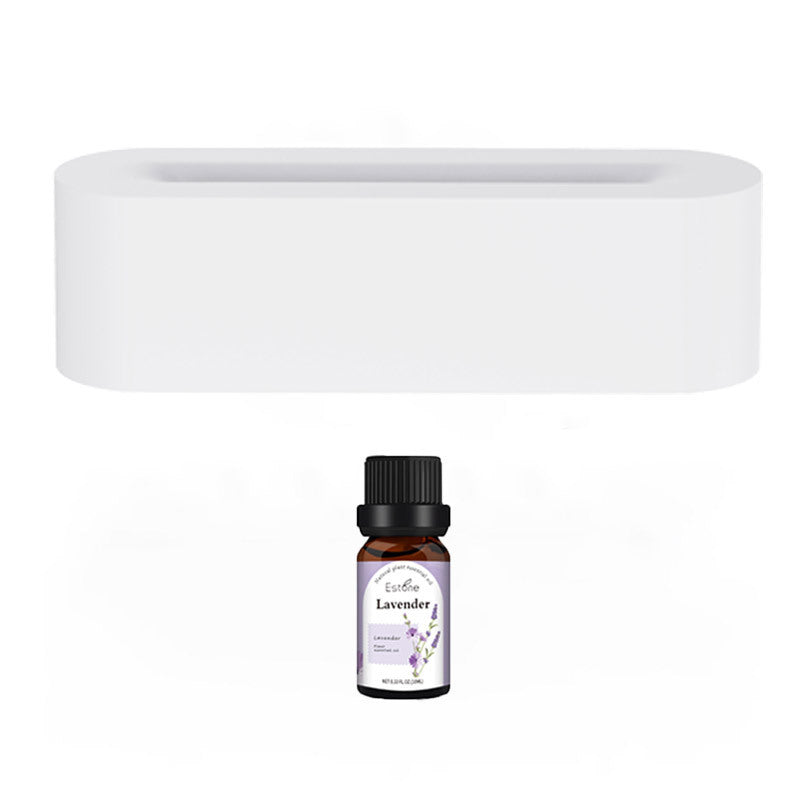 Sleek white aroma diffuser with cool mist humidifier and essential oil bottle containing lavender oil for relaxing scent.