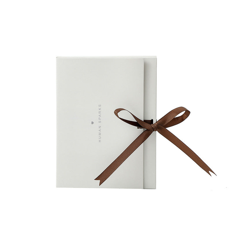 Elegant white gift box with brown ribbon bow, perfect for luxury perfume or other premium product from 6ixDrips store.