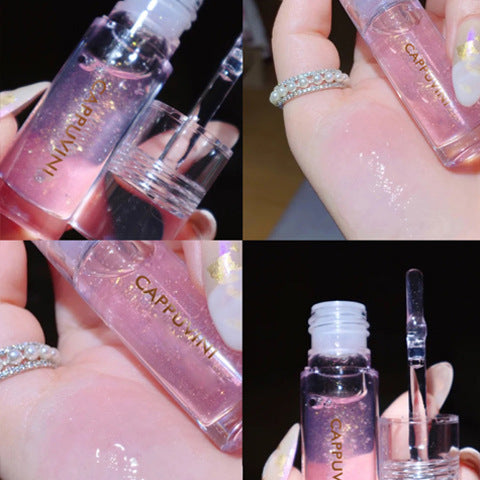 Sparkling pink lip gloss in transparent glass bottle, moisturizing lip balm, diamond-like rhinestone bracelet, shimmery cosmetic applicator