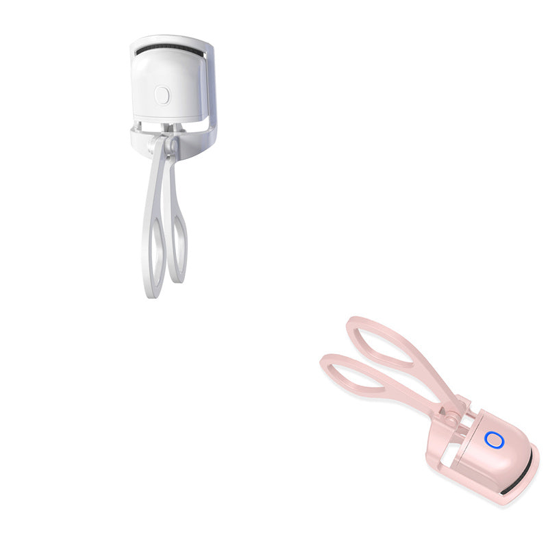 Heated eyelash curler with electric temperature control and a mini eyelash groomer in a white and pink color scheme.