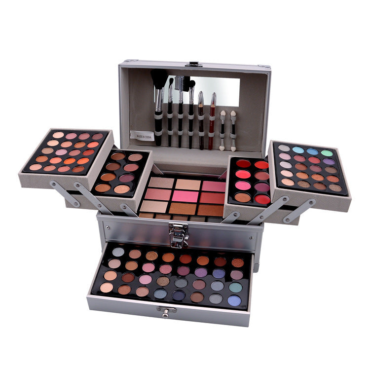 Comprehensive makeup kit in a stylish grey case. Includes an assortment of eyeshadows, lip colors, and blush palettes, providing a versatile selection of cosmetic products for a complete makeup look. The organized storage compartments allow for easy access and portability.